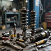 Shock absorber installation tips with various tools and components on a workshop table.