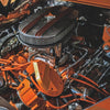 Close-up of an engine showcasing innovations in automotive parts technology with vibrant orange components.